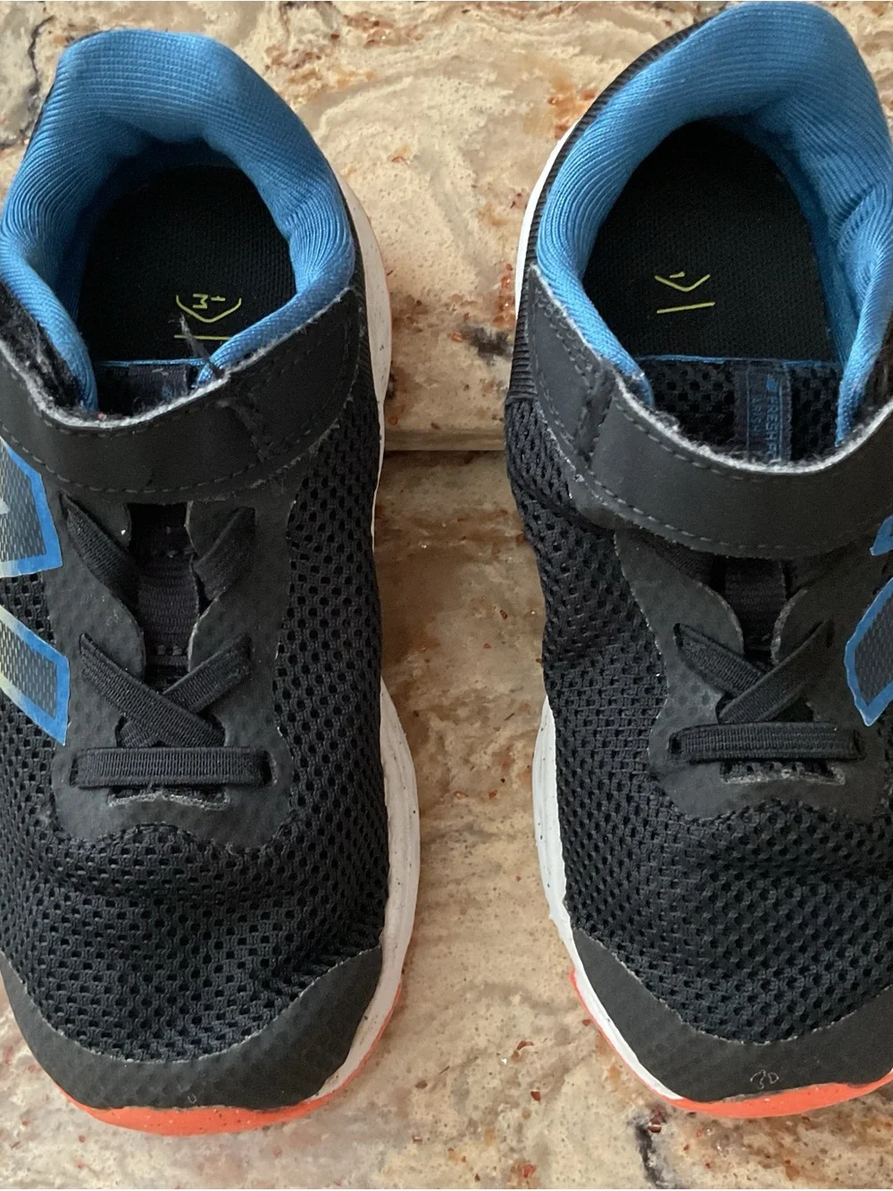 New Balance Kids Black Sneakers with Blue Lining and Coral Accent